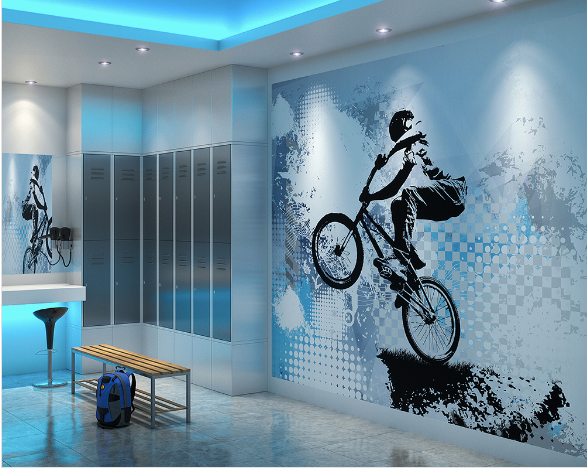 The action shot of a rider on a BMX bike soaring through the air on a dirt track depists the scene in this This Biking BMX Wall Mural. The blue, white, and grey tones give a fee for sport and adrenalin.