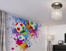 colourful soccer balls splashing in paint